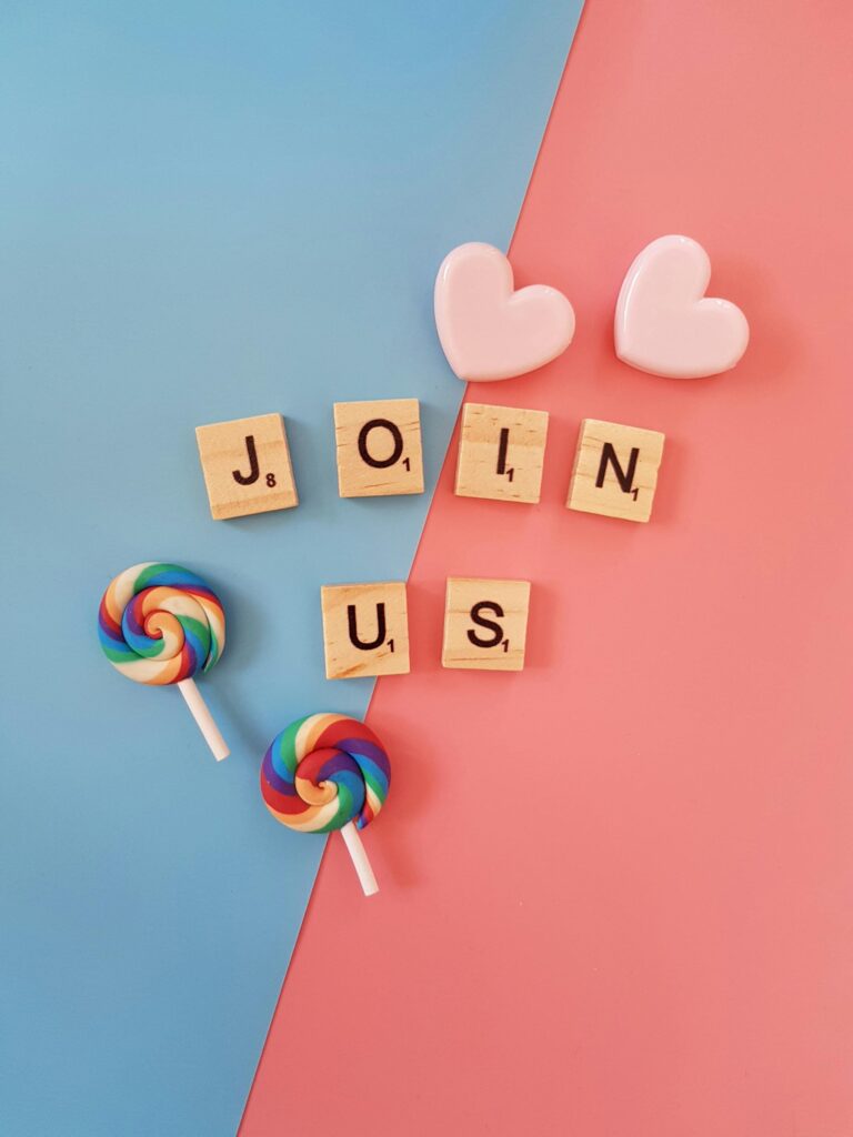 Bright 'Join Us' call-to-action with colorful lollipops and hearts on a pastel background.